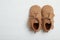 Top view of child`s booties on wooden background, space for text