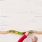 Top view on child`s hand playing with toy train and railway on white wooden table background