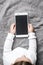 Top view child sitting and holding blank screen mock-up mobile phone AI generated