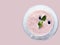 Top view of chilled pastel pink drink in double glass cup with blueberry and mint leaf