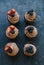 Top view of chocolate cupcakes with cream and berries.