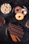 Top view of chocolate tablets, donuts, brown sugar with peanuts in chocolate and coffee beans