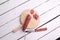 Top view of a Chorizo on a wooden board on a wooden table with a knife on it