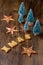 Top view Christmas decoration, of stars and trees, with cookies shaped like letters, on dark wooden table