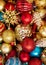 Top view of christmas decorations for christmas tree: gold and red balls, snowflake, golden pine cone. Shiny new year decorations