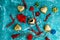 Top view of Christmas golden heart-shaped balls and various ornaments on blue background