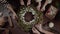 Top view Christmas wreath on craft background, pretty women hands preparing Christmas Evergreen Tree Wreath.