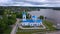 Top view of church with blue domes on river bank. Clip. White church with blue roof and domes on bank of river with