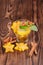 Top view of cinnamon tea cup on a dark wooden background. A sweet tea cup with carambola, mint leaves and cinnamon. Copy space.