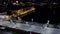 Top view of city dam with water at night. Stock footage. Beautiful view of city bridge with dark water reflecting lights