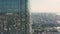 Top view of city reflected in windows of glass business skyscraper. Stock footage. Beautiful reflection of city in glass