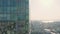 Top view of city reflected in windows of glass business skyscraper. Stock footage. Beautiful reflection of city in glass