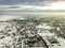 Top view of city suburbs or small town nice houses on winter morning on cloudy sky background. Aerial drone photography concept