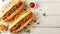 Top view of classic sandwich and fries on wooden table with empty space above for text placement