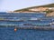 Top view from the cliffs of the Aegean sea and a fish farm on the Greek island of Evia in Greece on a Sunny day