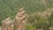 Top view a climber pulls a safety rope while sitting on top of a mountain.