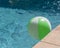 Top view close-up beach ball near swimming pool coping