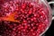 Top view, close-up preparation of freshly picked cherries with sugar to make cherry sauce filling for ice cream, jam