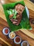 Top view Close up traditional local style food juicy yummy tasty fried roasted sliced meat pork on nature green banana leaf