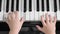 Top view of closeup Asia boy playing piano at home. Used ten fingers to press piano key
