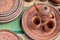 Top view closeup of beautiful Gujarati Khavda Pottery earthen terracotta crockery tea cups kettle and tray at a roadside market