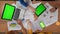 Top view closeup of boardroom desk with young male and female workers, laptop smartphone and tablet. Advertising area