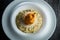 top view closeup boiled barley porridge with breaded whole pear