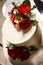 top view closeup creamy wedding cake with red roses