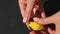 Top view closeup female hands put yellow lemon shaped candy into brown stand