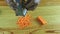 Top view closeup man hands grate small peace of fresh carrot on metal grater