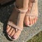 Top view and closeup photo of woman feet in T strap sandals