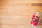 Top view closeup of a plastic white transparent jar with three sewn hearts on a wooden table