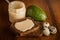 top view closeup quail eggs, jar with tahini, rye bread, whole avocado