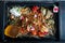 top view closeup restaurant dish of crumbled bark bread and sliced radish