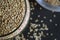 Top View Closeup Sesame Seeds in a Open Transparent Glass jar On isolated Black Background