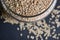 Top View Closeup Sesame Seeds in a Open Transparent Glass jar On isolated Black Background