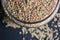 Top View Closeup Sesame Seeds in a Open Transparent Glass jar On isolated Black Background