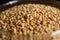 Top View Closeup Sesame Seeds in a Open Transparent Glass jar On isolated Black Background