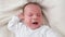 Top view closeup shot of newborn baby boy crying beacuse of feeling hungry