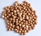 Top view closeup shot of a pile of chickpeas on a white surface