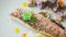 Top view closeup trendy decorated baked fish fillet with vegetables rotates on plate