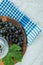 Top view of a cluster of black grapes with leaf and a glass of wine