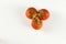 top view of cluster of tomatoes with drops on white background