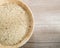 Top view -Coarse rice on the wooden plate and on wooden background