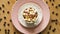 Top view of coffee with marshmallows on pink plate and wooden table