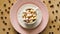 Top view of coffee with marshmallows on pink plate and wooden table