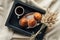 top view of coffee and muffins on tray with lagurus ovatus bouquet on beige cloth breakfast