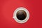 Top view of a coffee mug. Vector cup of coffee on a vivid red desktop background.
