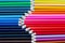 Top View of Collection of Colorful Pencil Crayons Lined Up in Rows Together Meeting at the Tips or Points