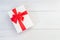 Top view color gift box with ribbon on white wooden plank